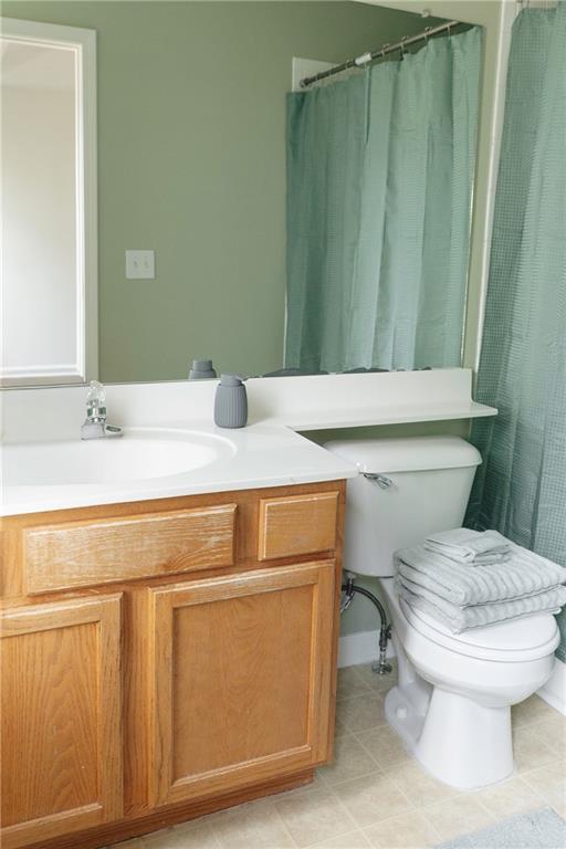 340 Timber Gate Court Lawrenceville, GA 30045 - Photo 18 of 26 a bathroom with a sink a toilet and a mirror