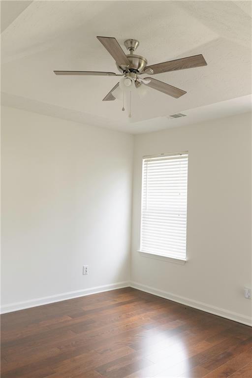 340 Timber Gate Court Lawrenceville, GA 30045 - Photo 22 of 26 an empty room with wooden floor fan and windows