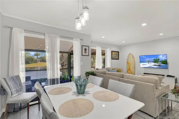 a living room with furniture a dining table and kitchen view
