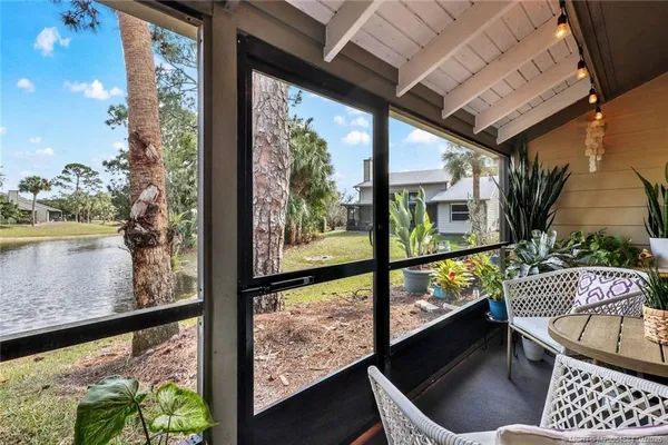 a view of a balcony with chair and wooden floor