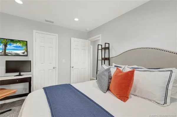a bedroom with a bed and a desk