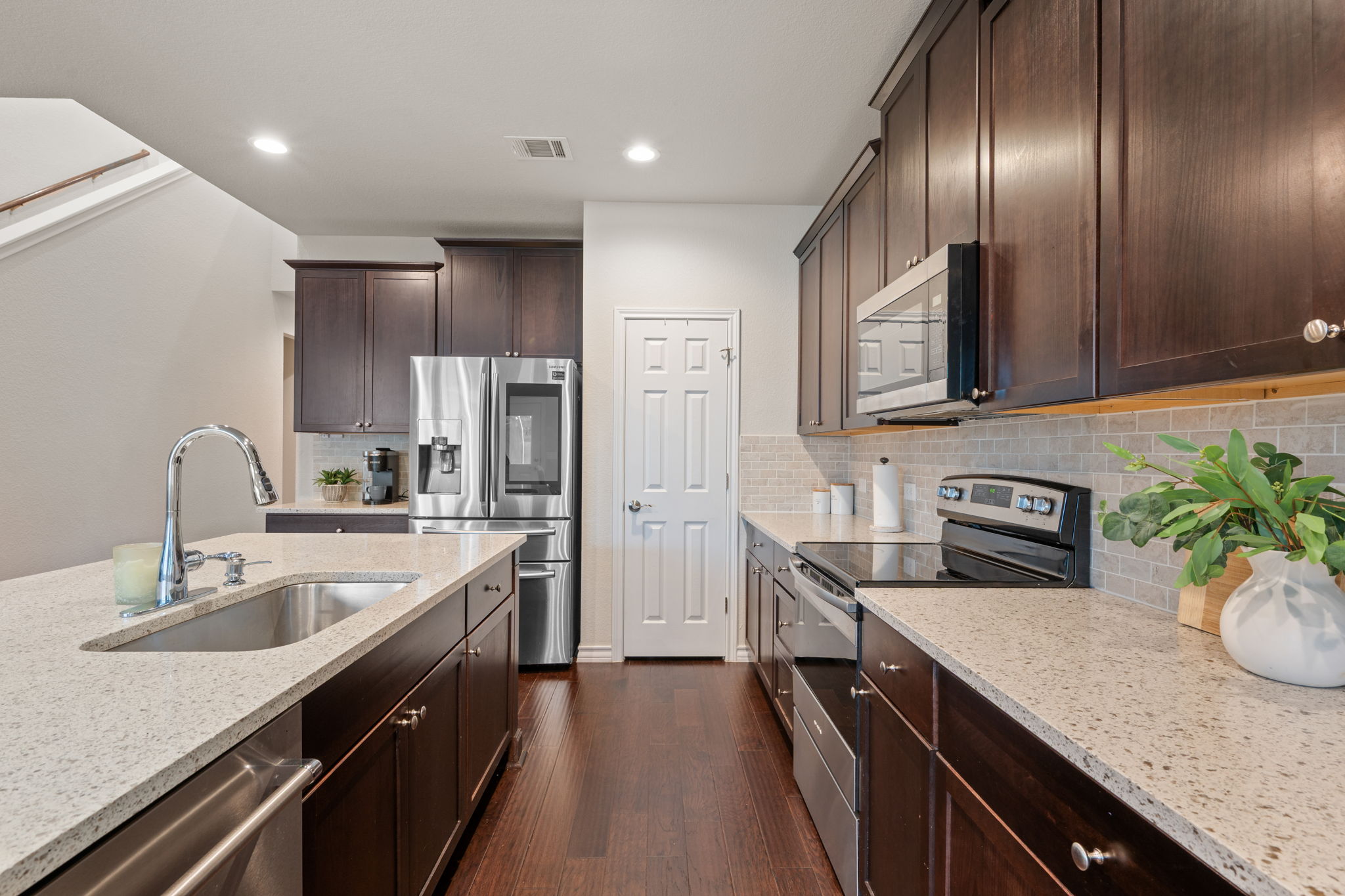 409 Limestone Road Liberty Hill, TX 78642 - Photo 8 of 35 a kitchen with stainless steel appliances granite countertop a sink a stove and refrigerator