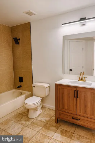 a bathroom with a sink a toilet and bathtub