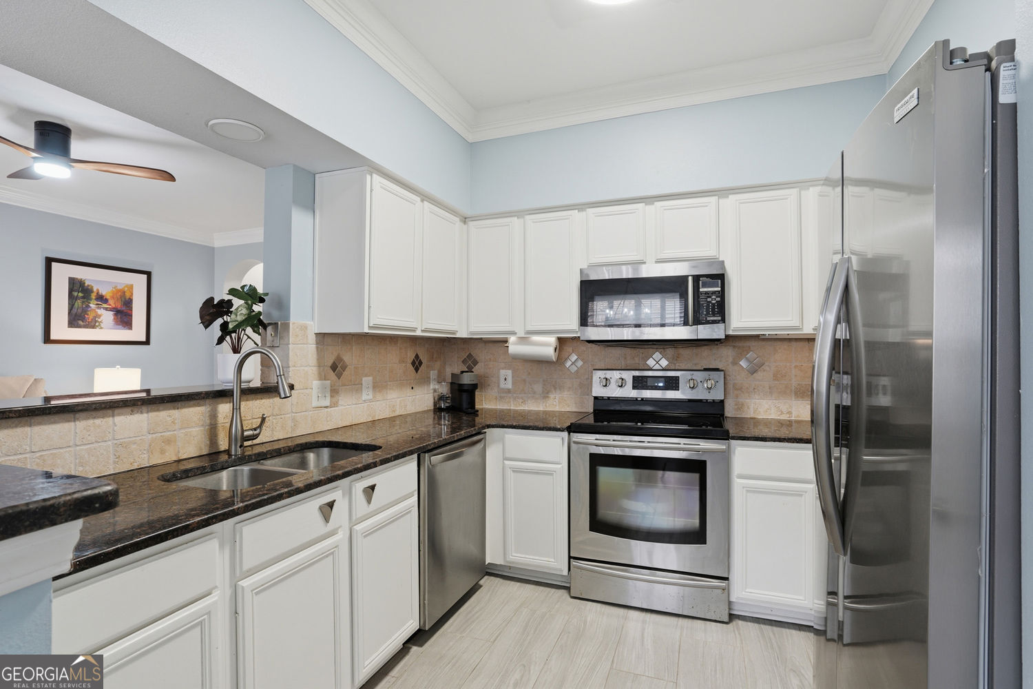 3777 Peachtree Road Northeast Brookhaven, GA 30319 - Photo 6 of 26 Kitchen has ample Counter Space and Cabinets, S/S Appliances, Granite & Tile Backsplash