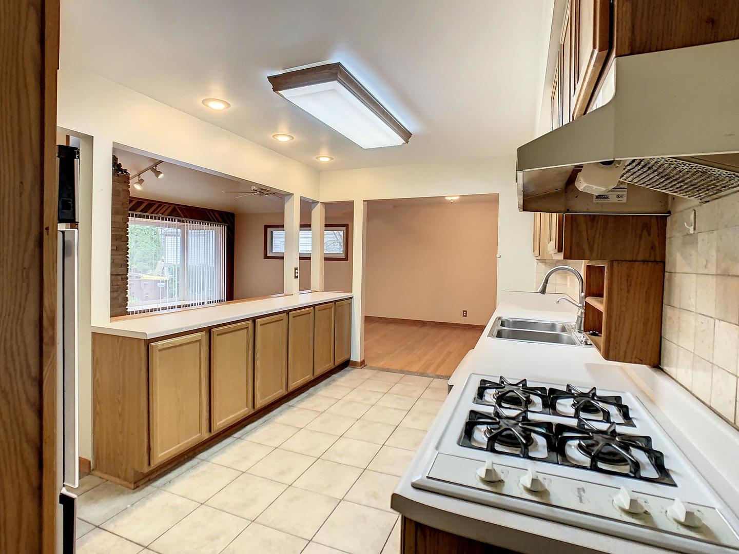 4705 Timberlane Road Crystal Lake, IL 60014 - Photo 11 of 29 a kitchen with a stove and a sink