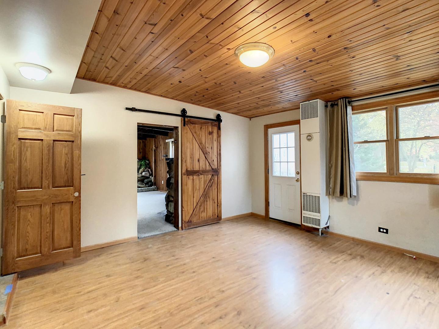 4705 Timberlane Road Crystal Lake, IL 60014 - Photo 13 of 29 a view of an empty room with wooden floor and entryway