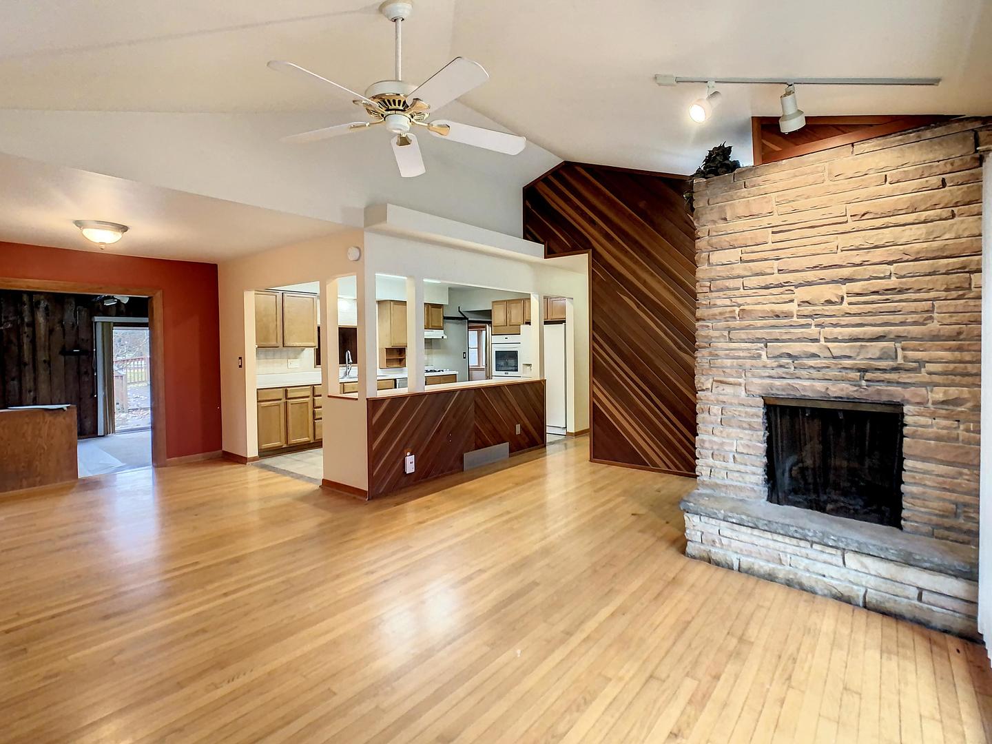 4705 Timberlane Road Crystal Lake, IL 60014 - Photo 5 of 29 a view of a livingroom with a fireplace a ceiling fan and wooden floor