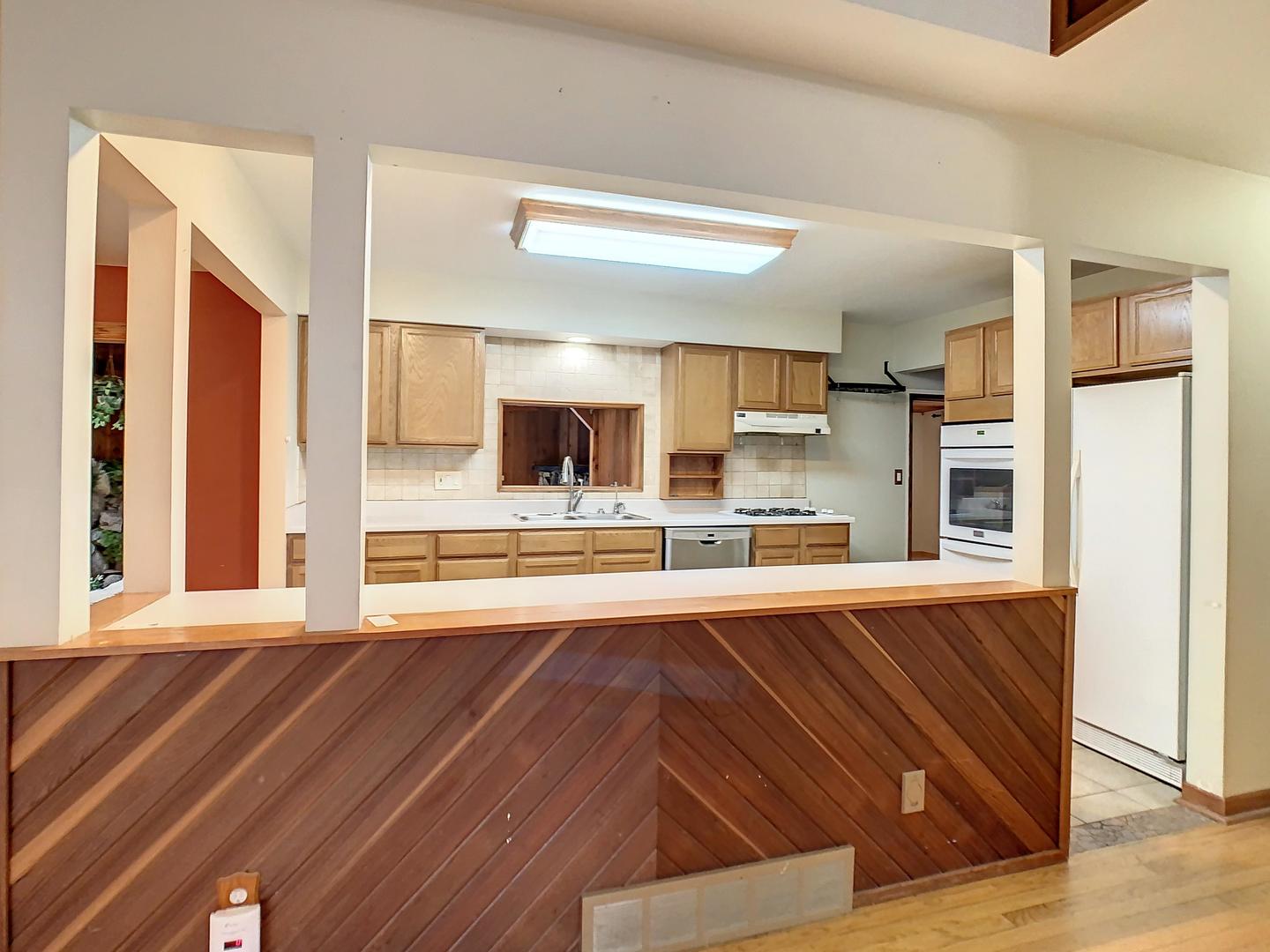 4705 Timberlane Road Crystal Lake, IL 60014 - Photo 8 of 29 a view of an empty room with kitchen and window