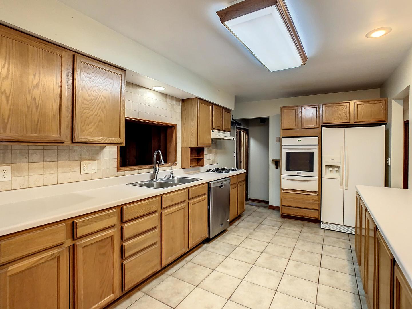 4705 Timberlane Road Crystal Lake, IL 60014 - Photo 9 of 29 a kitchen with stainless steel appliances a sink and cabinets