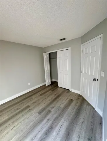 a view of an empty room and wooden floor