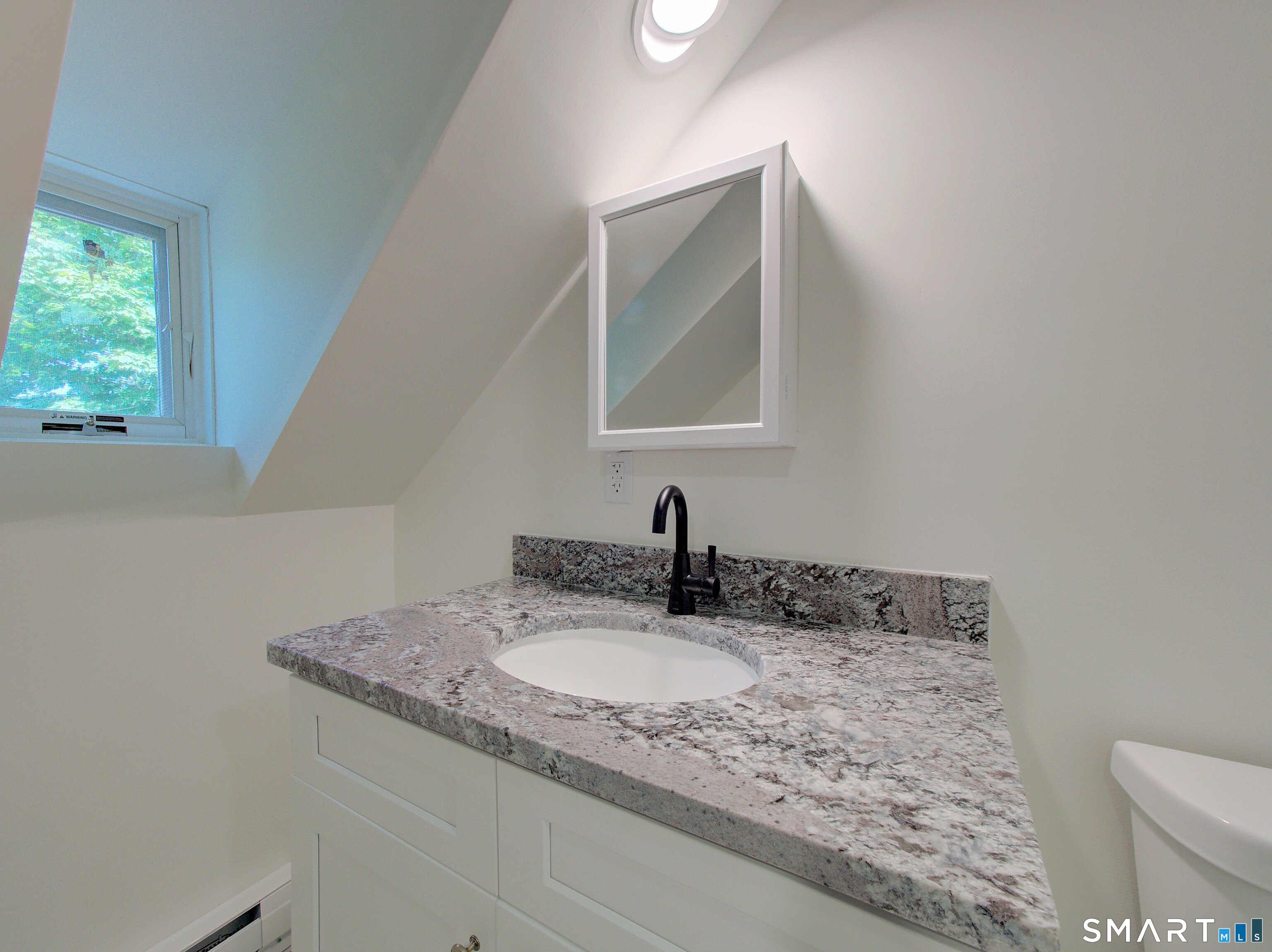 16 Benham Road, Unit D Groton, CT 06340 - Photo 4 of 15 a bathroom with a granite countertop sink and a mirror