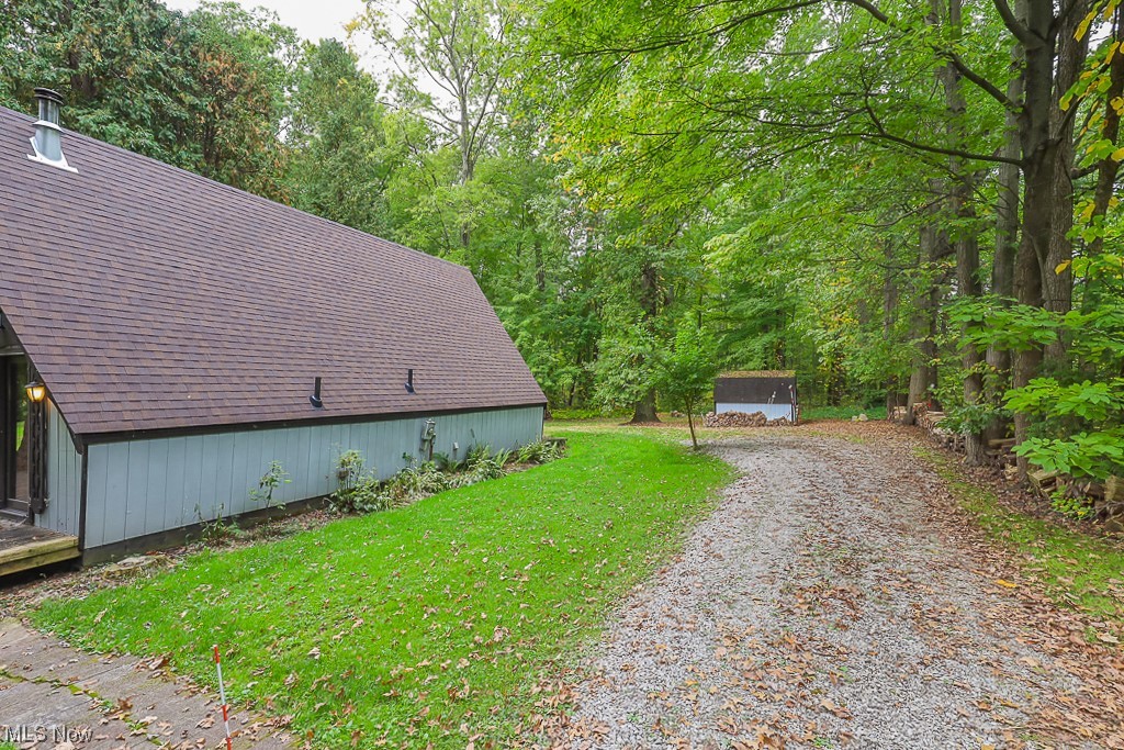 9920 Reed Road Grafton, OH 44044 - Photo 23 of 28 Drive by the side of the home leading to parking area