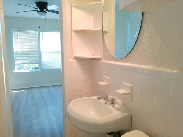 a view of a small space with wooden floor and a window