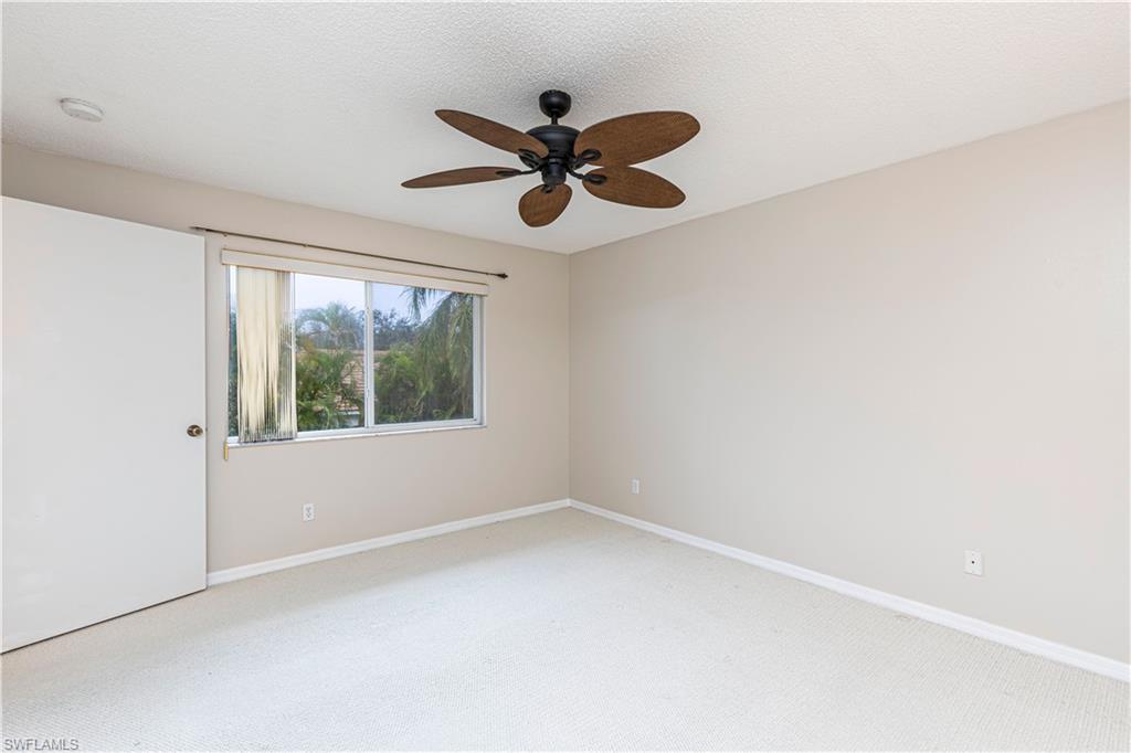 7761 Jewel Lane, Unit 202 Naples, FL 34109 - Photo 18 of 27 Spare room featuring carpet floors and ceiling fan