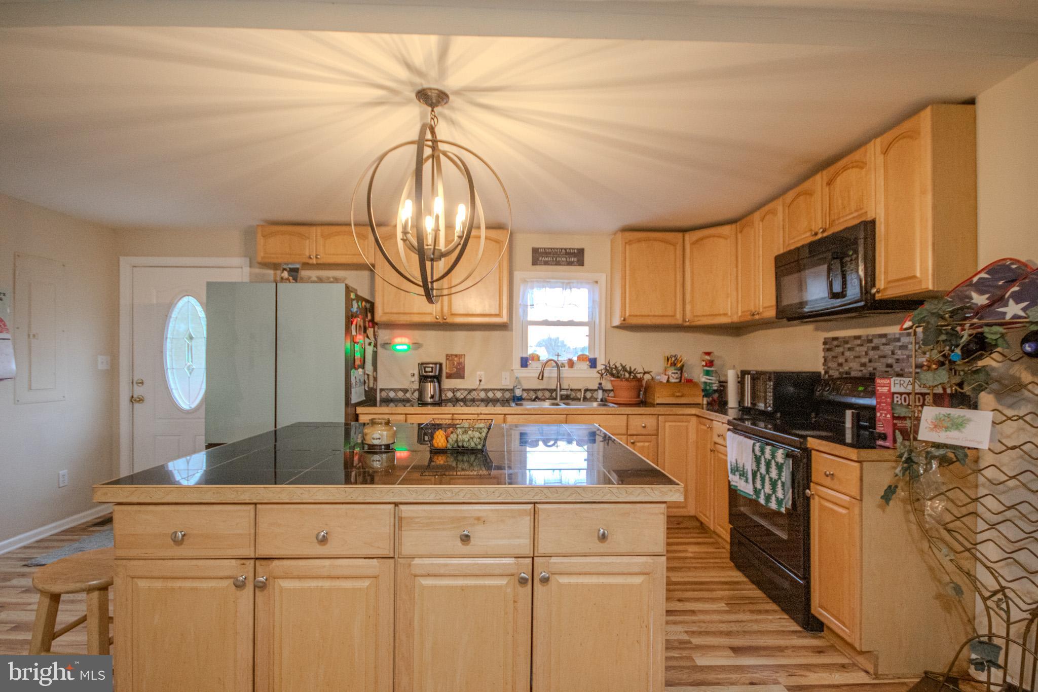 101 Culver Street Hebron, MD 21830 - Photo 12 of 33 a kitchen with stainless steel appliances granite countertop a stove a sink and a microwave