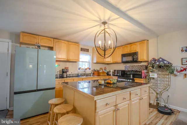 a kitchen with granite countertop a sink appliances cabinets and a counter top space