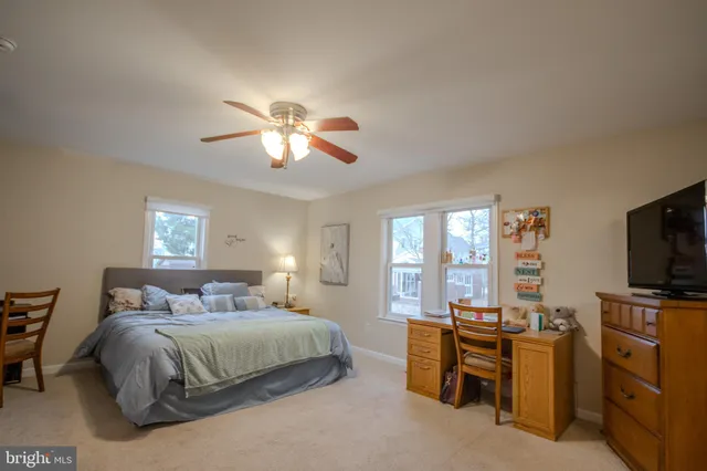 a bedroom with a bed and a television