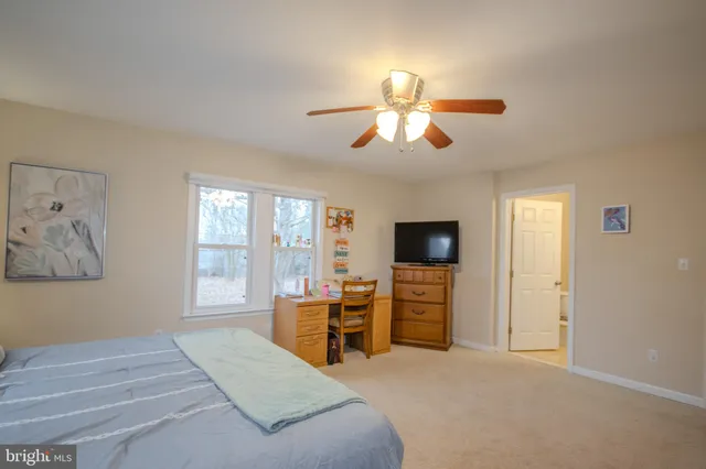 a bedroom with furniture and a flat screen tv