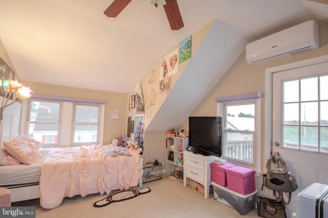 a spacious bedroom with a bed and large windows