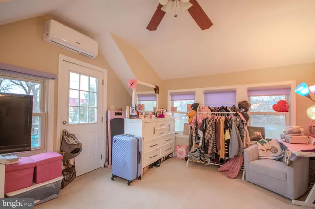 a bed room with furniture and a flat screen tv