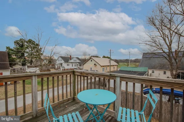 a view of a chair and table in the balcony
