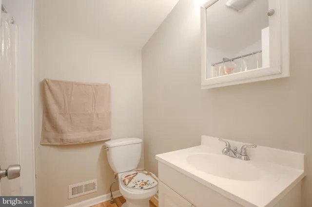 a white toilet sitting next to a bathroom sink