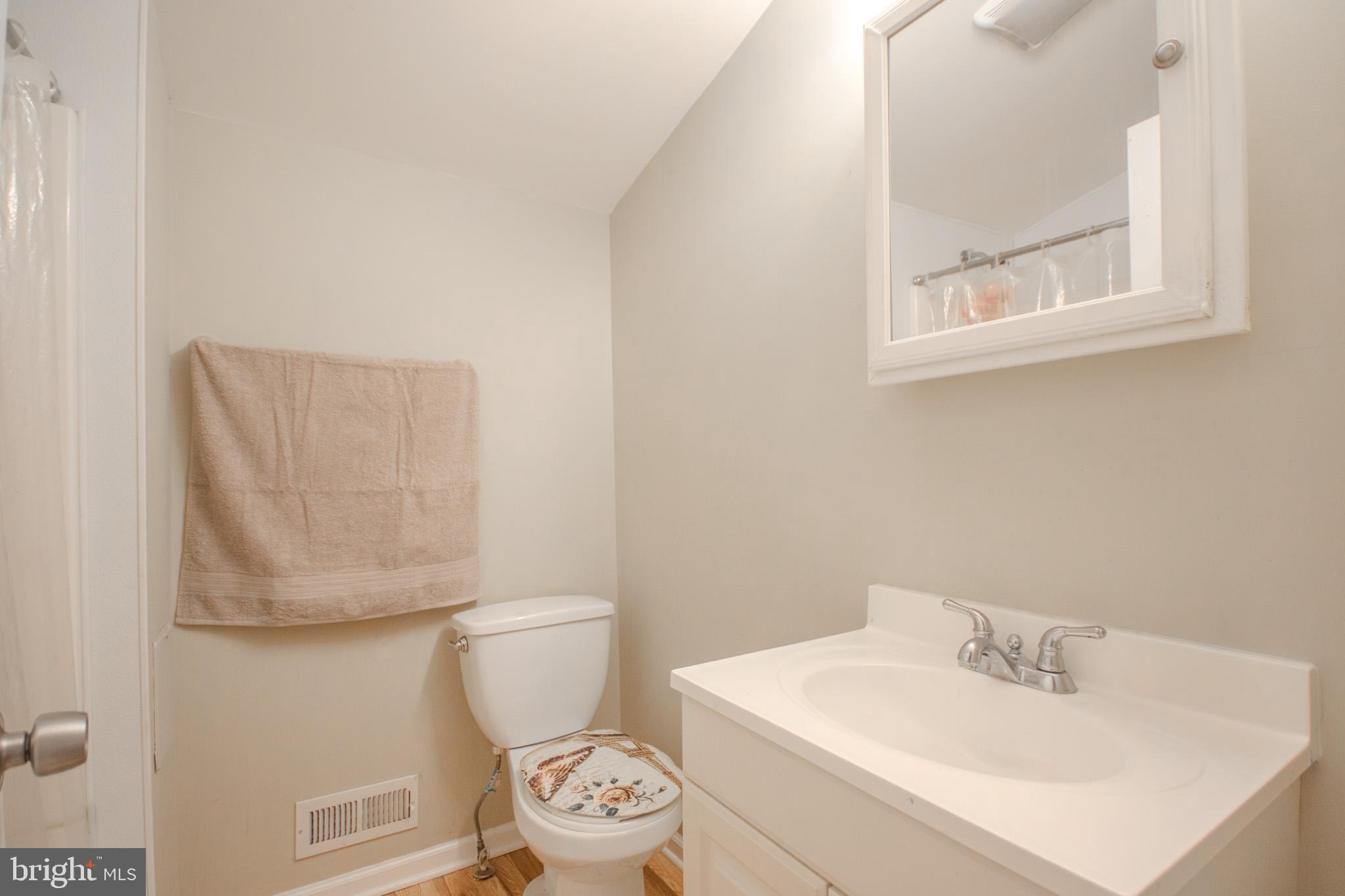 101 Culver Street Hebron, MD 21830 - Photo 26 of 33 a white toilet sitting next to a bathroom sink