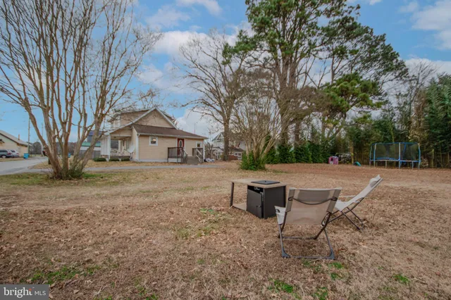 a view of a house with a yard and sitting area