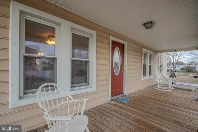 a balcony with table and chairs