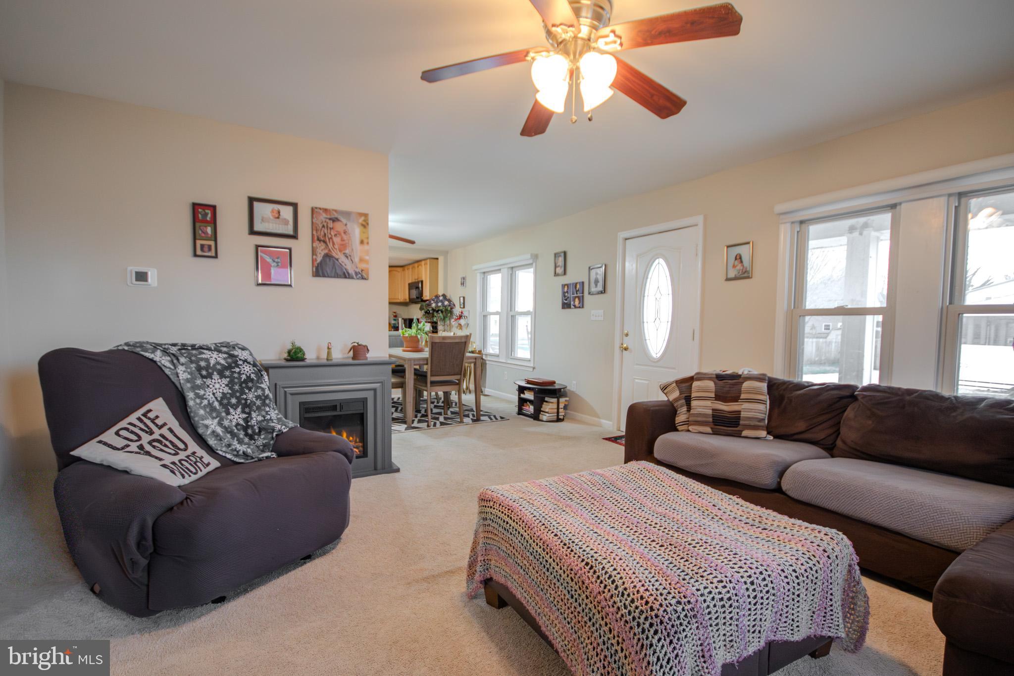 101 Culver Street Hebron, MD 21830 - Photo 7 of 33 a living room with furniture a large window and a chandelier