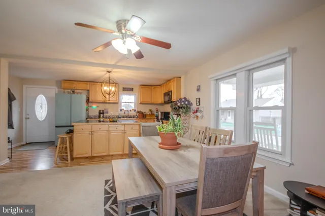 a view of a dining room with furniture and a large window