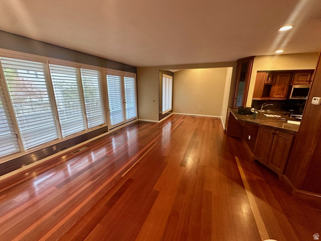 1715 Darling Street, Unit 3 Ogden, UT 84403 - Photo 6 of 26 Expansive living area featuring rich wood-finish flooring