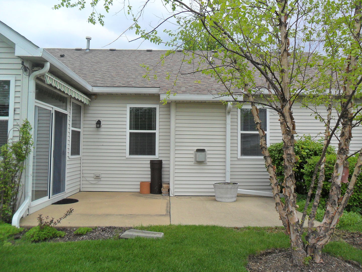 678 Cadillac Circle Romeoville, IL 60446 - Photo 16 of 19 a view of a white house next to a yard and large trees