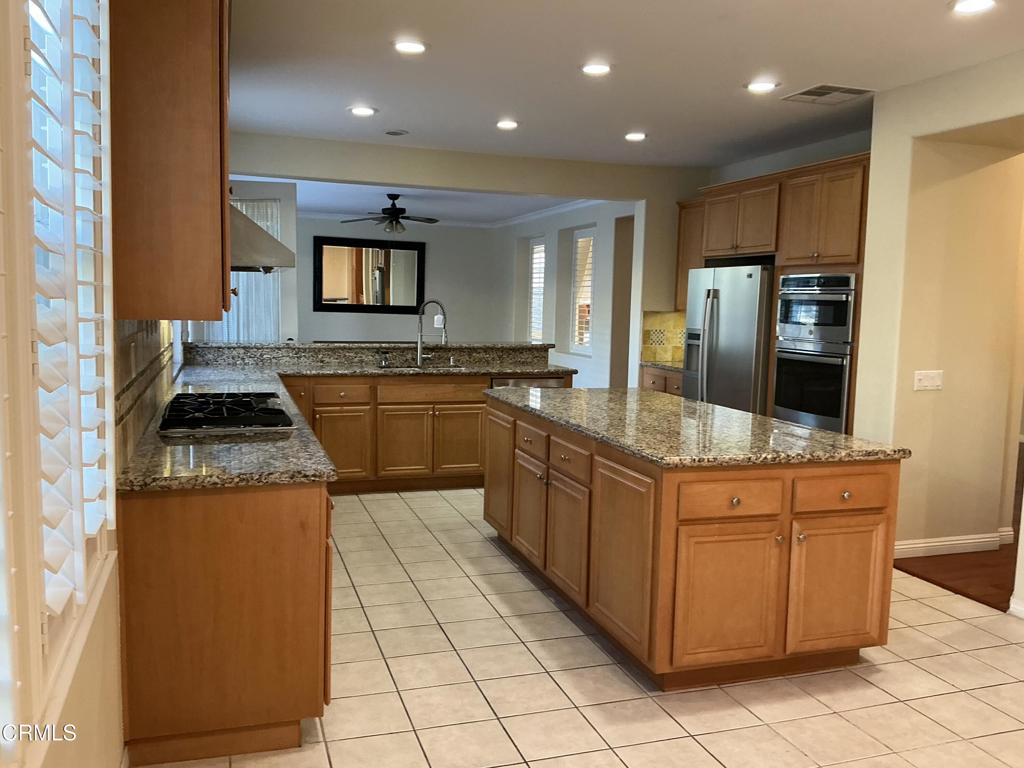 13687 Blue Ridge Way Moorpark, CA 93021 - Photo 11 of 56 a large kitchen with stainless steel appliances granite countertop a stove and a sink