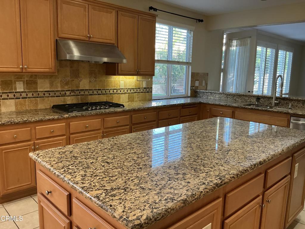 13687 Blue Ridge Way Moorpark, CA 93021 - Photo 12 of 56 a kitchen with stainless steel appliances granite countertop a sink stove and cabinets