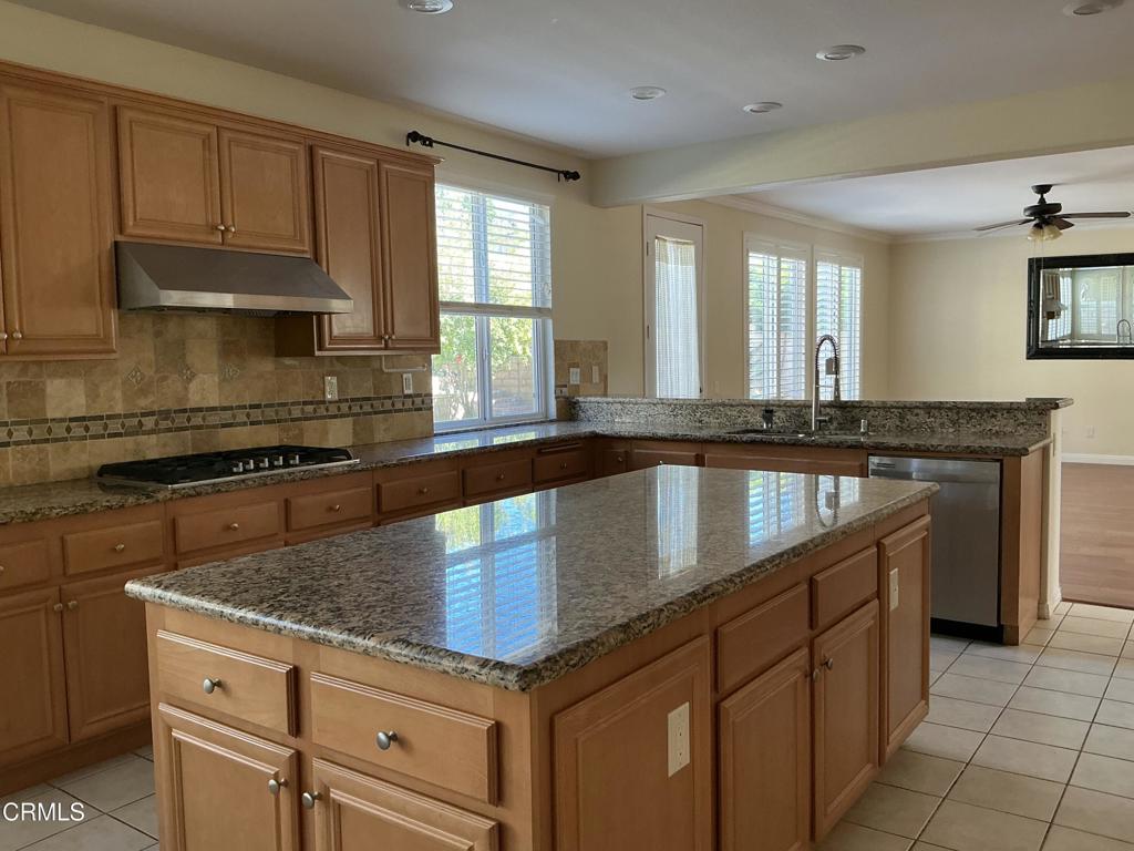 13687 Blue Ridge Way Moorpark, CA 93021 - Photo 17 of 56 a kitchen with granite countertop a sink a stove and cabinets