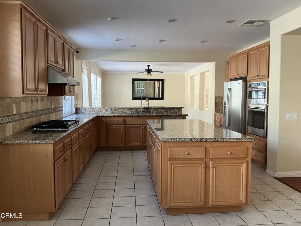 13687 Blue Ridge Way Moorpark, CA 93021 - Photo 18 of 56 a kitchen with stainless steel appliances granite countertop a sink stove and refrigerator