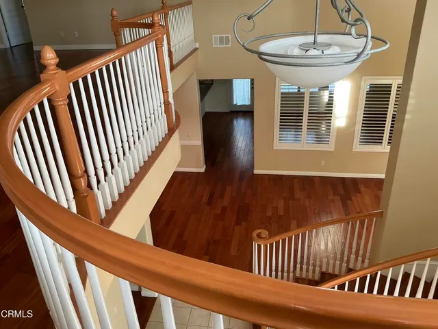 a view of a room with wooden floor and cabinet