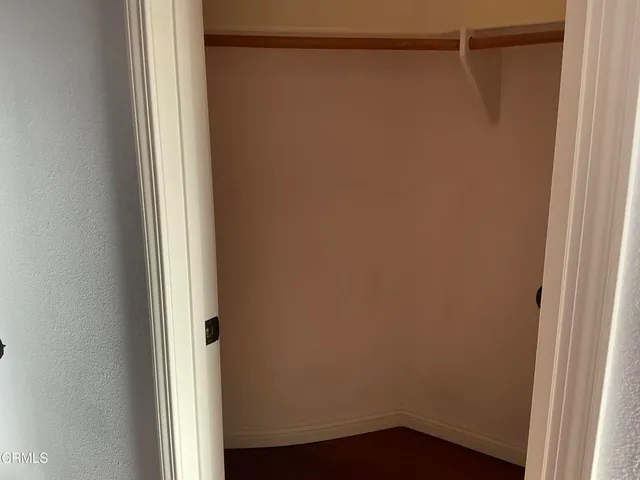 an empty room with wooden floor and a window