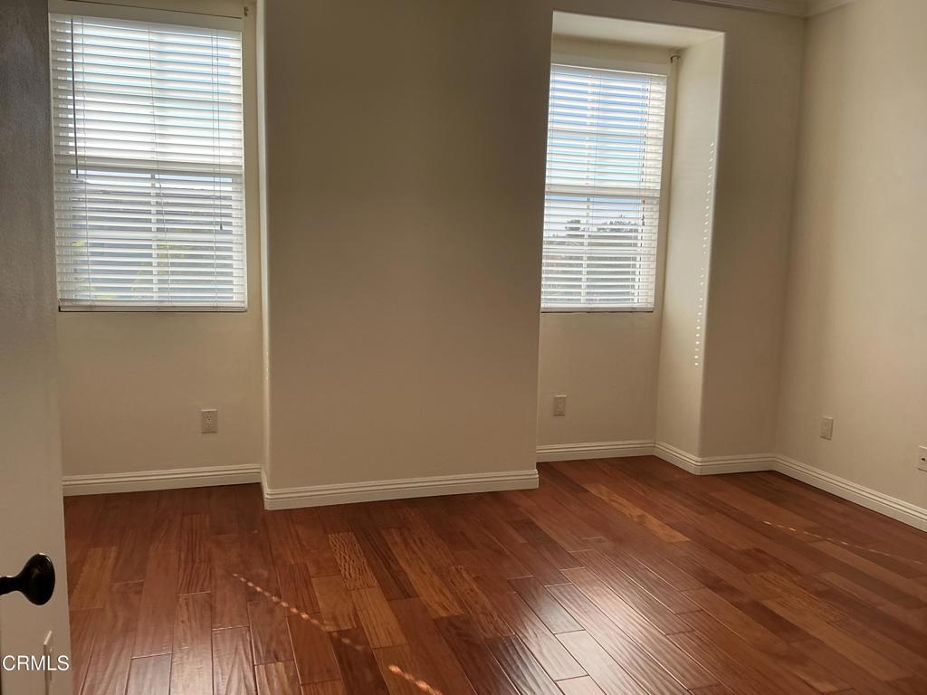 13687 Blue Ridge Way Moorpark, CA 93021 - Photo 36 of 56 an empty room with wooden floor and a window