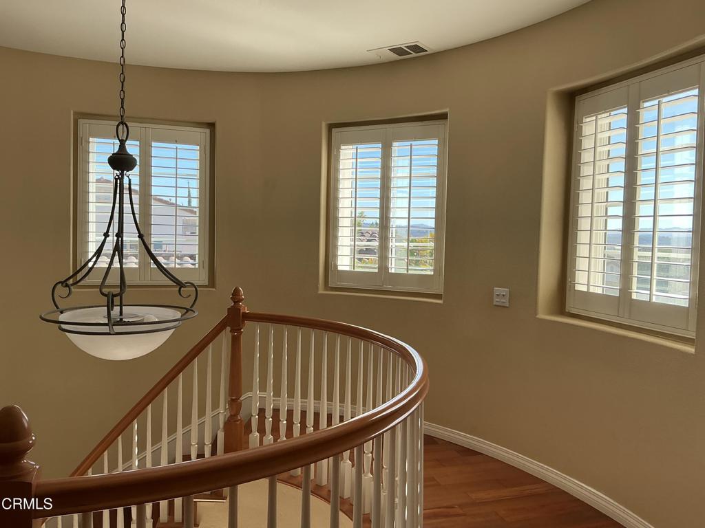 13687 Blue Ridge Way Moorpark, CA 93021 - Photo 54 of 56 a view of a hallway with wooden floor and windows