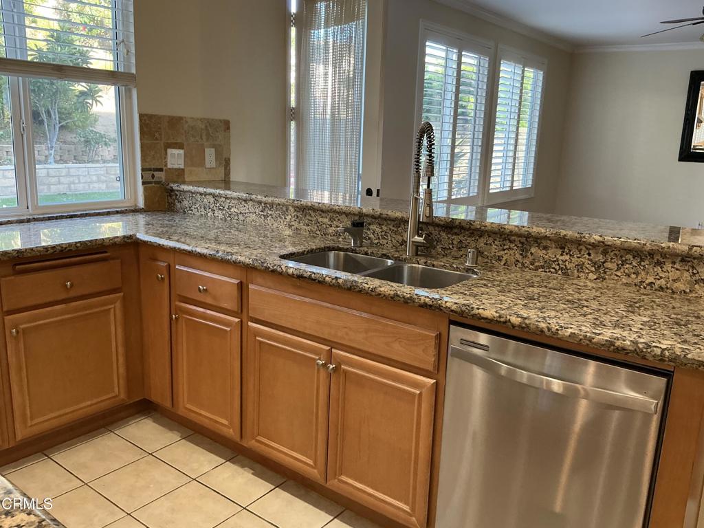 13687 Blue Ridge Way Moorpark, CA 93021 - Photo 56 of 56 a sink with granite countertop cabinets and window