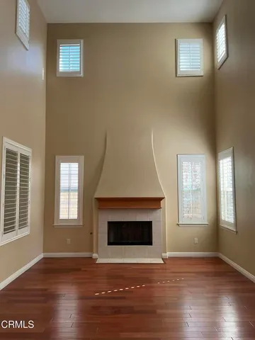 a view of a room with wooden floor and chandelier