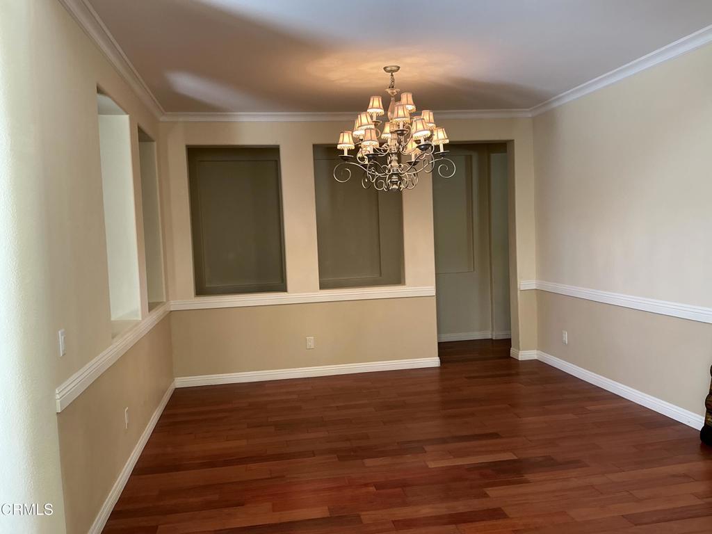 13687 Blue Ridge Way Moorpark, CA 93021 - Photo 9 of 56 a view of a room with wooden floor and chandelier