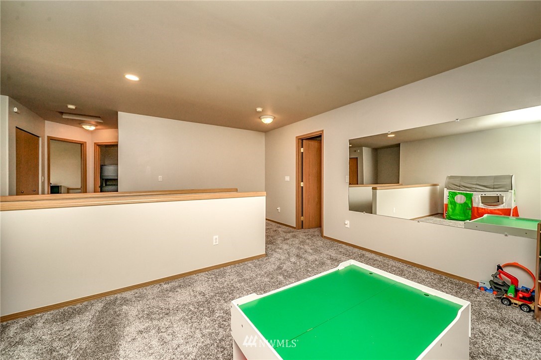 2206 Southeast 2nd Place Renton, WA 98056 - Photo 22 of 39 a living room with a couch and a table with wooden floor