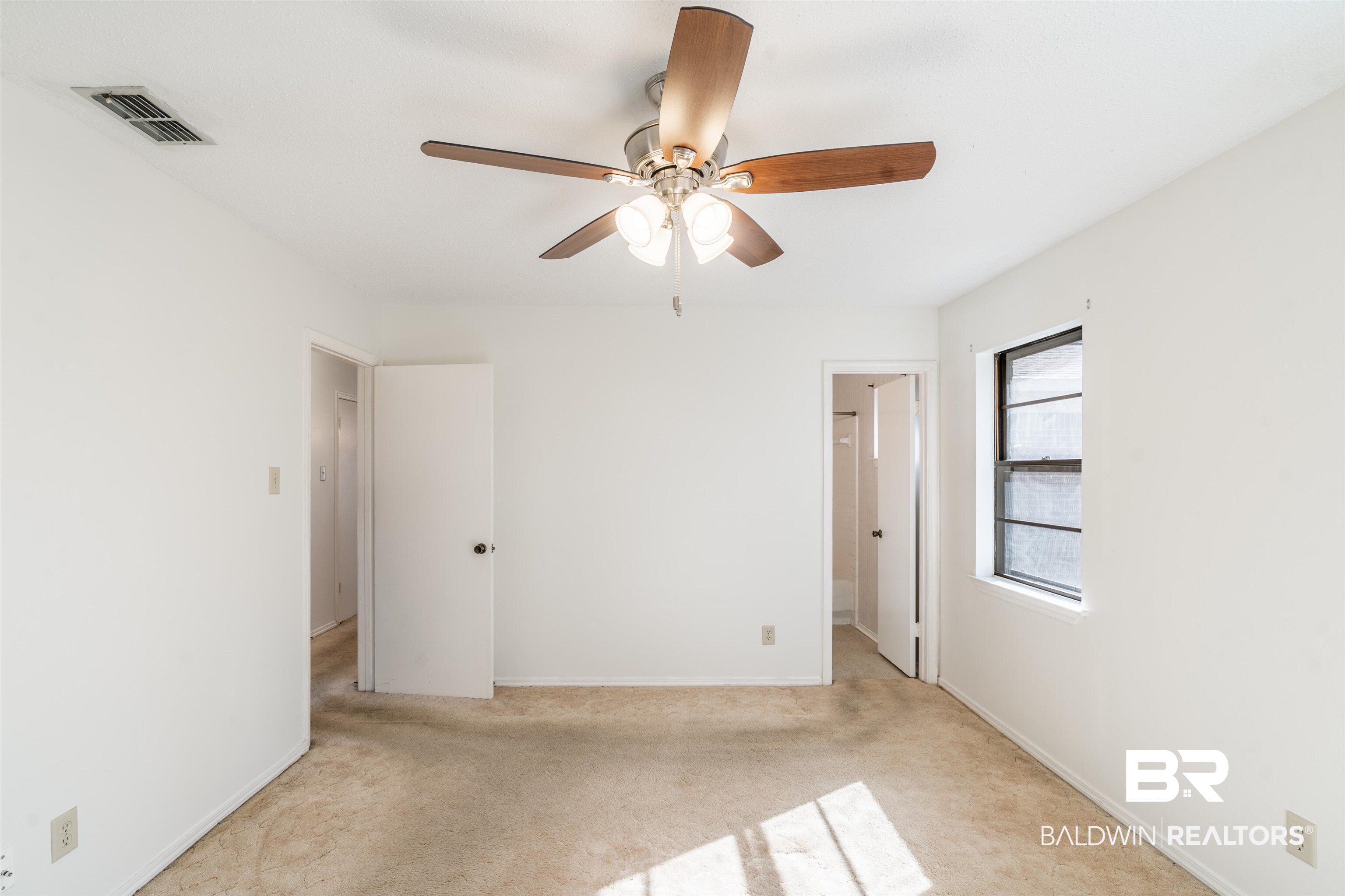 9751 Pine Knoll Road Mobile, AL 36608 - Photo 25 of 36 Unfurnished bedroom featuring light carpet, a ceiling fan, and a spacious closet