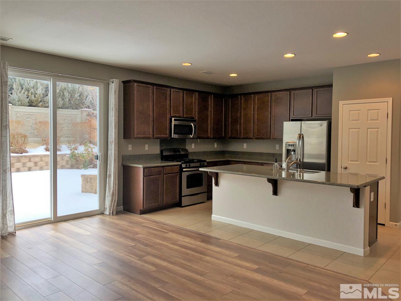 2035 Angel Ridge Drive Reno, NV 89521 - Photo 4 of 23 a kitchen with a refrigerator sink and cabinets