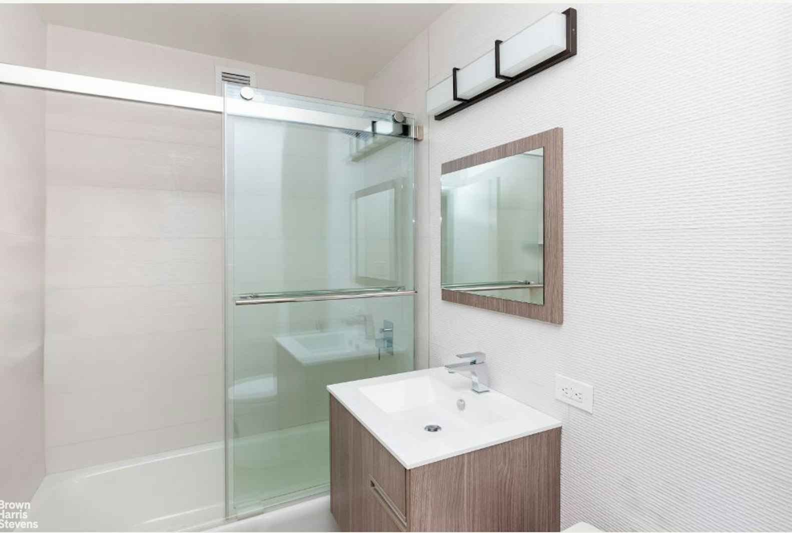 2521 Palisade Avenue, Unit 8C Bronx, NY 10463 - Photo 12 of 17 a bathroom with a sink mirror and shower
