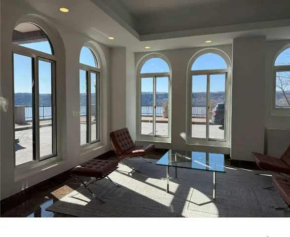 a living room with furniture and large windows