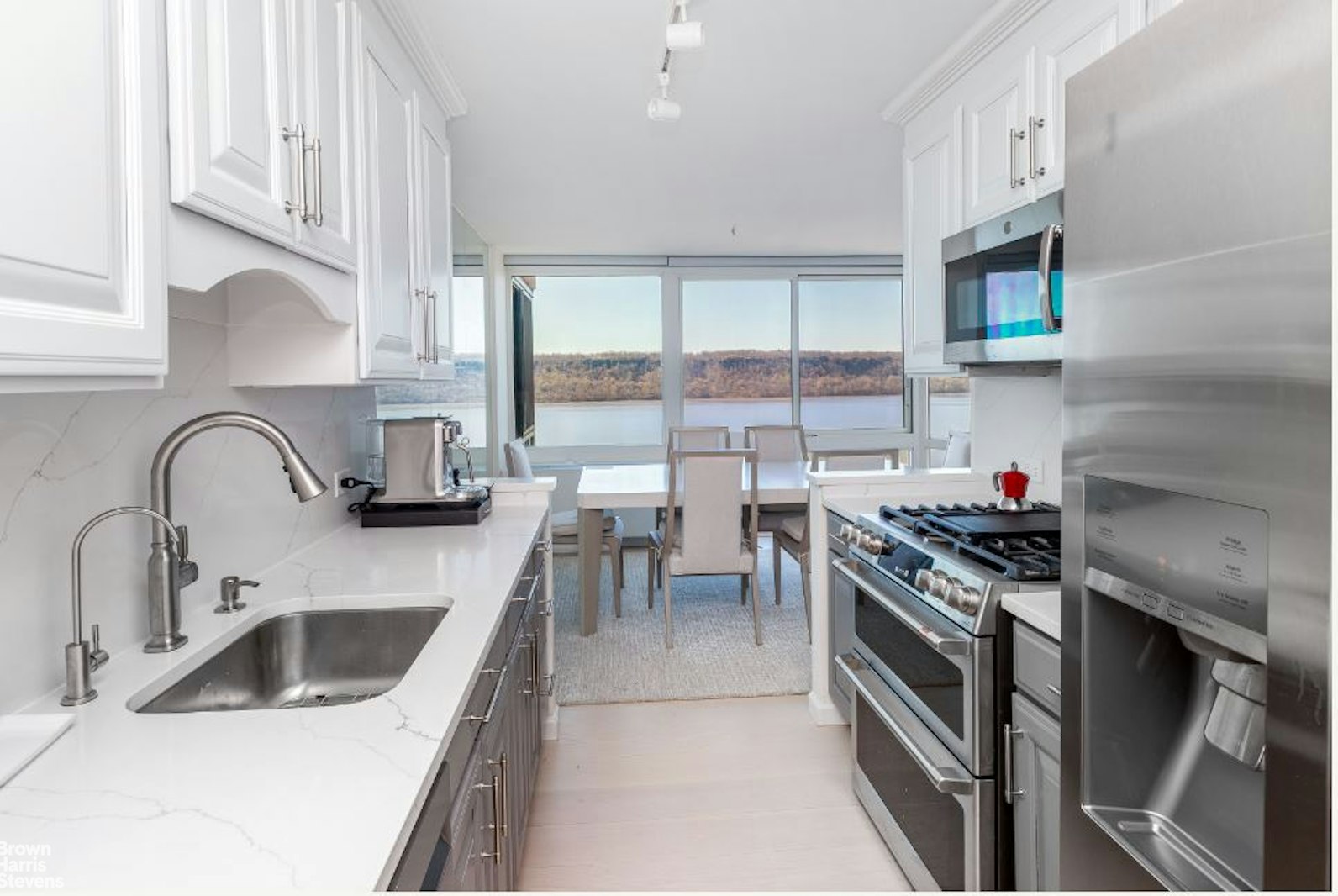 2521 Palisade Avenue, Unit 8C Bronx, NY 10463 - Photo 5 of 17 a kitchen with stainless steel appliances a sink stove and cabinets